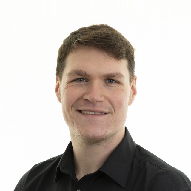 Jay Lyle smiling, wearing a black shirt